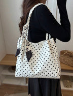 Sac cabas à pois porté à l'épaule