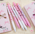 Set scolaire de 6 stylos gel roses et blancs avec motifs nœuds